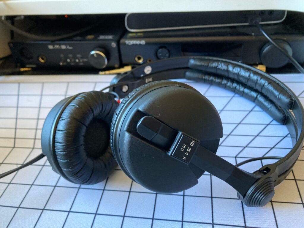 Mis auriculares todoterreno  Sennheiser HD 25-1 II. Destras se puede ver un amplificador S.M.S.L SP200 y un Topping DX7 Pro (amplificador + DAC)